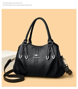 Detail of black pebbled leather texture with embossed kangaroo logo on a luxury handbag
