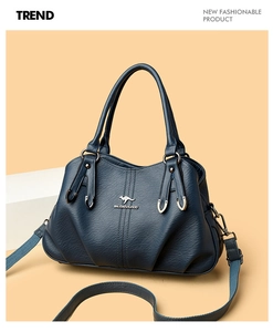 Close-up of soft blue pebble leather texture and kangaroo logo on the handbag
