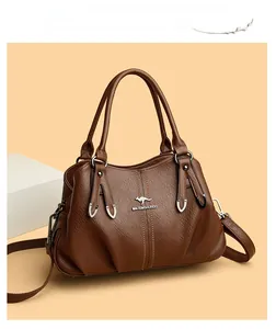 Detailed view of dark brown faux leather bag featuring a textured pebble grain and metal logo