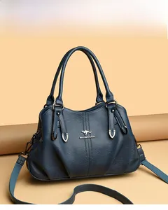 Detailed view of navy blue leather handbag with kangaroo metal logo and zipper texture