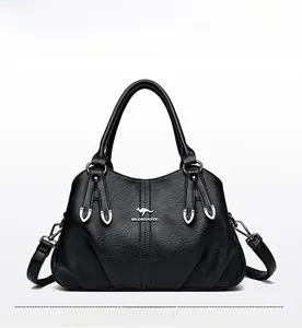 Detailed view of the black leather texture and kangaroo metal logo on the handbag