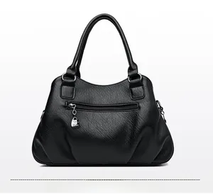 Rear view of black soft leather handbag showing functional back zipper pocket and texture