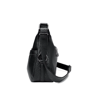Classic black leather crossbody bag with wide fabric strap and textured lychee pattern
