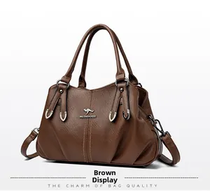 Detail of soft brown pebble leather handbag with silver kangaroo logo and double handles