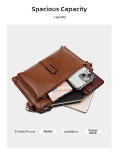 Macro view of the brown leather crossbody bag showing multiple pockets and high capacity