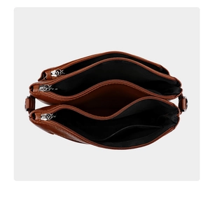 Top view of classic brown crossbody bag with triple zipper compartments and silver hardware