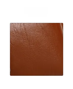 Detailed close-up of brown litchi pattern leather fabric with soft texture and glossy finish