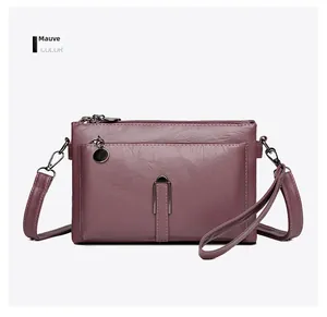 Detail view of the bean paste pink PU leather multi-layer crossbody bag with zippers