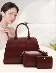 Detail view of burgundy leather tote bag set including handbag, pouch and wallet