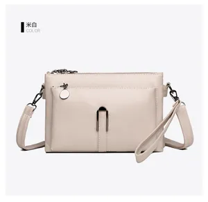 Detail view of off-white PU leather bag showing multi-layer zipper and magnetic pocket