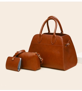 Detailed view of the 3-piece vintage brown leather tote bag set with golden hardware