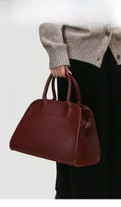 Detailed close-up of dark red matte synthetic leather tote bag with fine litchi grain texture