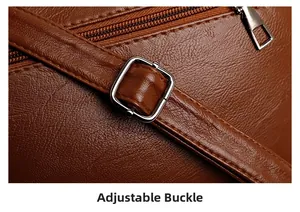 Detail of adjustable buckle and brown lychee grain leather on a stylish shoulder bag