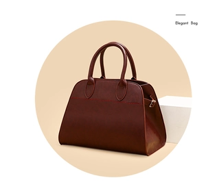 Close-up of vintage faux leather tote with elegant red stitching and smooth texture
