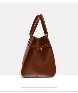 Detail of vintage brown tote bag side straps and ergonomic handles in smooth PU leather