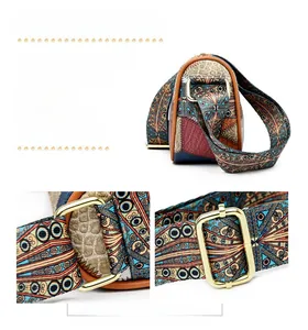Detail view of colorful patterned crossbody bag with wide woven strap and gold hardware