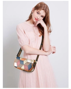 Detail of color-block leather crossbody bag featuring a retro patterned wide strap