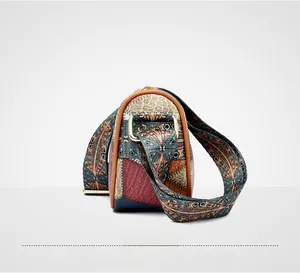 Detail view of ethnic patchwork shoulder bag with bohemian patterns and gold hardware