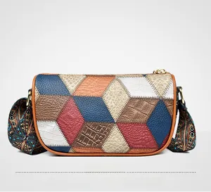 Detail of multi-texture patchwork crossbody bag with wide patterned woven shoulder strap