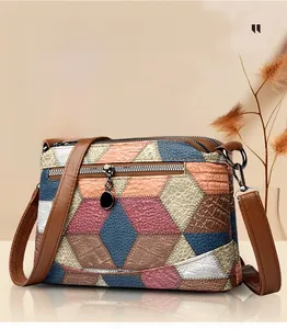 Close-up of multicolor patchwork crossbody bag with pebble leather and silver zipper