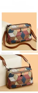Detail of color-block geometric PU leather bag with metal ring zipper and brown strap
