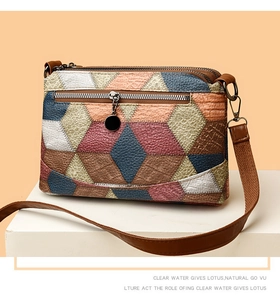 Macro detail of multicolor faux leather texture and metallic zipper on crossbody bag