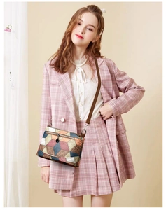 Detail of multi-color geometric pattern shoulder bag with 3D diamond patchwork design