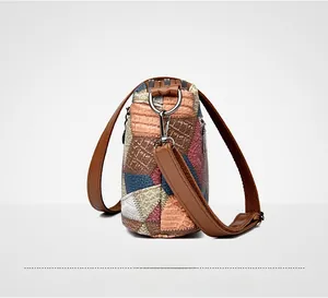 Detail view of colorful patchwork leather handbag with embossed crocodile texture and strap