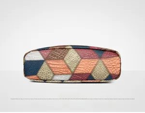 Detail view of the colorful patchwork leather base with various embossed textures