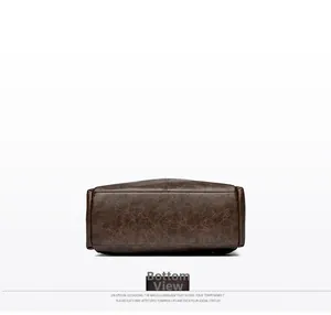 Detail view of the vintage brown leather bag bottom featuring precise stitching and texture