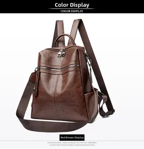 Detail of red-brown oil wax leather backpack with vintage texture and metal zippers