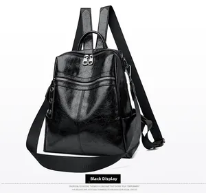 Detailed view of black vintage leather backpack with textured finish and dual zippers