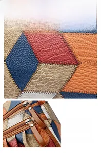Dettaglio macro del patchwork in pelle multicolore e hardware della cerniera in metallo