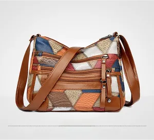 Dettaglio delle texture in pelle patchwork multicolore e tre tasche frontali con zip della borsa