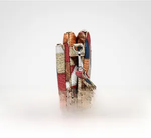 Detail view of colorful patchwork leather clutch featuring a three-layer compartment structure