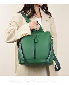 Detail view of the green lychee pattern leather texture and side pockets on the backpack