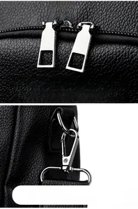 Close-up of black litchi pattern leather bag with metal zippers and detachable hooks