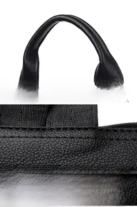 Close-up of comfortable leather handle and precise stitching on black anti-theft backpack