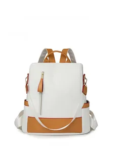 Close-up of a large capacity travel backpack in white and tan with front vertical zipper