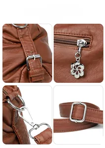 Detail of silver hardware on brown leather bag with flower zipper pull and strap hooks