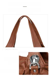 Detail of reinforced stitching on brown PU leather handles with silver metal hardware