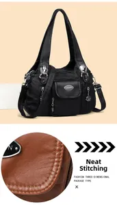 Detailed view of meticulous stitching and premium leather texture on black shoulder bag