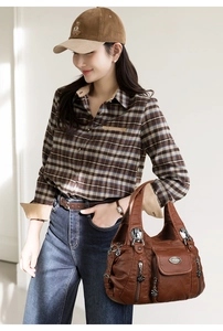 Detailed view of brown vintage multi-pocket shoulder bag with premium soft leather texture