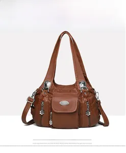 Front view of a brown vintage leather handbag with pleated texture and silver hardware