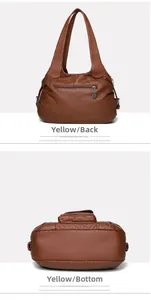 Close-up of brown faux leather shoulder bag showing back zipper pocket and bottom detail