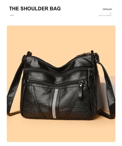 Close-up of black PU leather bag showing double zippers and silver rhinestone trim details