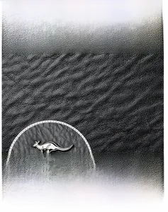 Detail of black lychee grain leather texture with silver kangaroo logo emblem