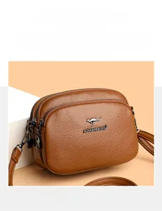 Detail of brown litchi pattern leather bag with metal kangaroo logo and dual zippers