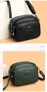 Detail of soft litchi texture leather shoulder bag with triple zipper compartments