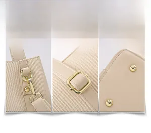 Detailed view of light gold metal buckles and woven fabric on the beige tote bag